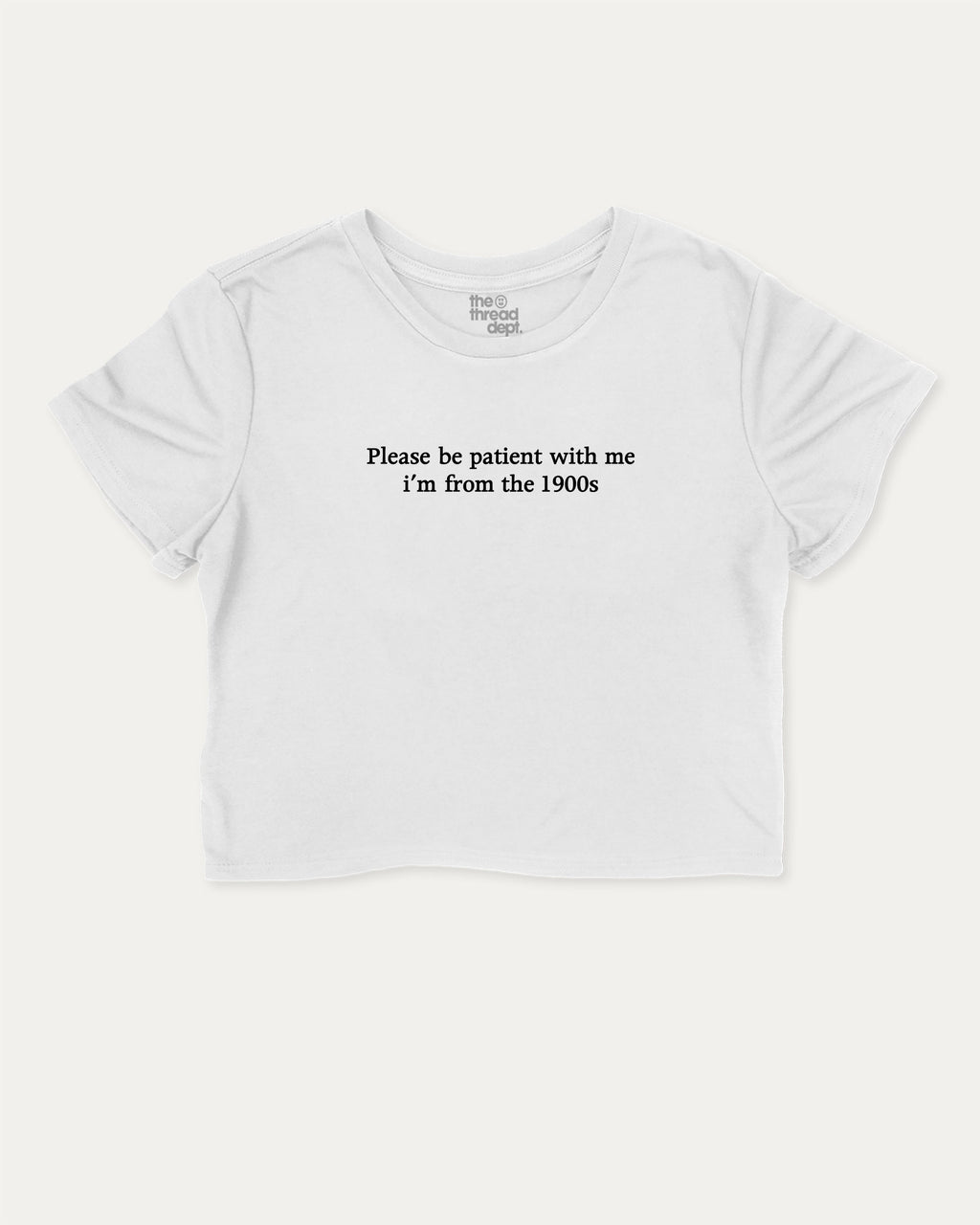Please Be Patient With Me I'm From The 1900s graphic crop tee with funny and retro slogan print, perfect for women_ casual looks or layering. White crop t-shirt.