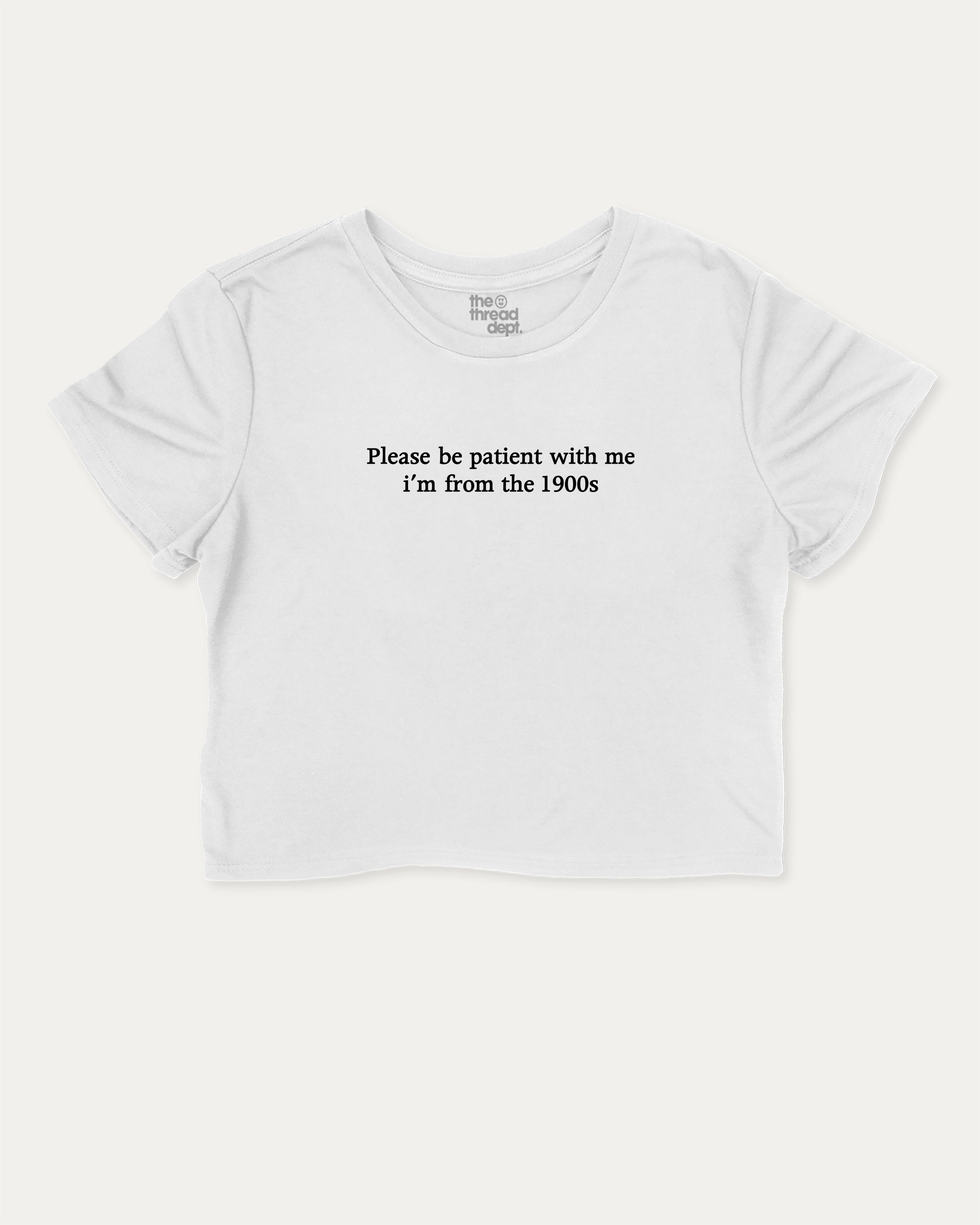 Please Be Patient With Me I'm From The 1900s graphic crop tee with funny and retro slogan print, perfect for women_ casual looks or layering. White crop t-shirt.