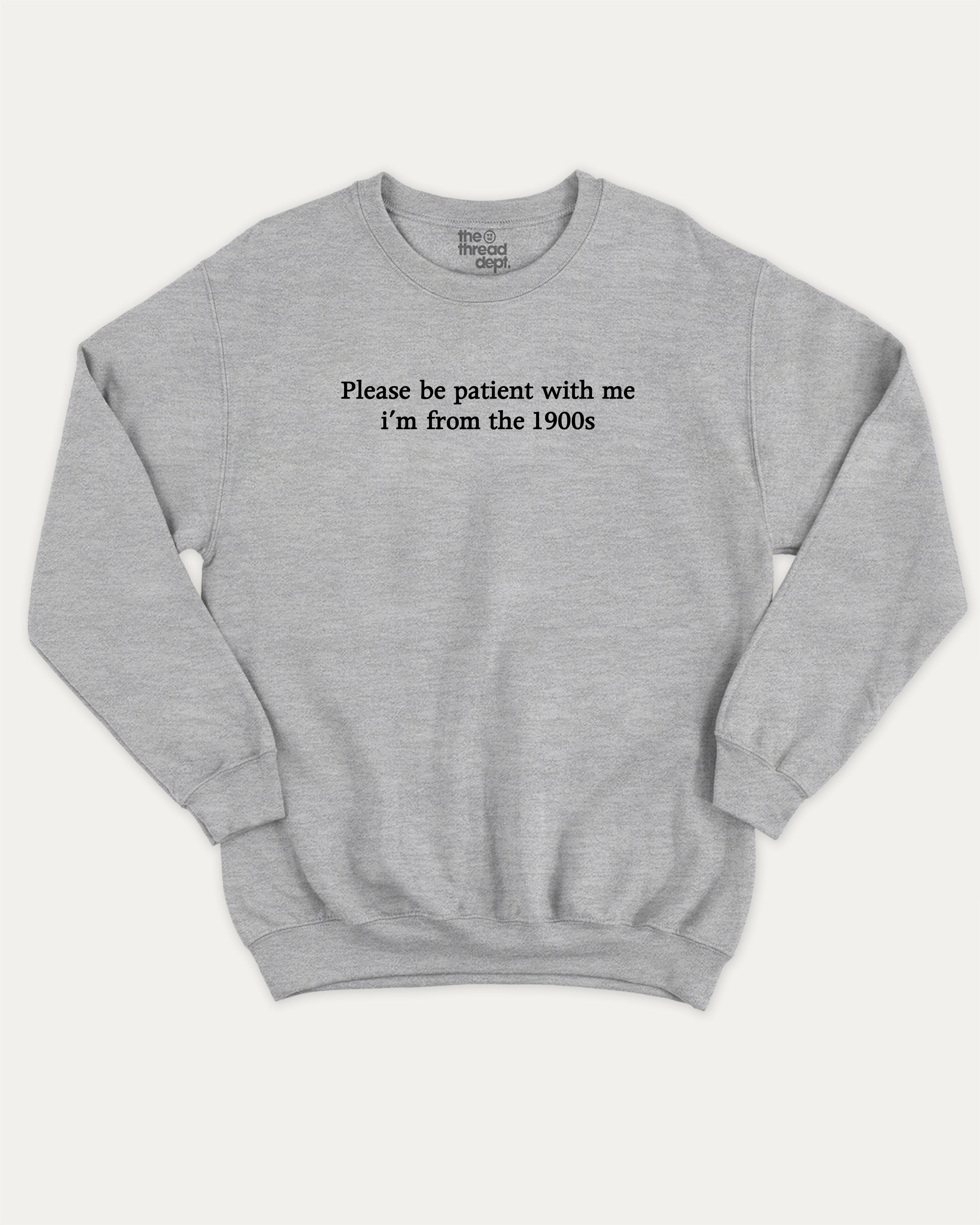 Please Be Patient With Me I'm From The 1900s graphic sweatshirt with retro and humorous print, warm and cozy graphic for everyday wear. Perfect for adults and gift-giving. Heather Grey pullover.