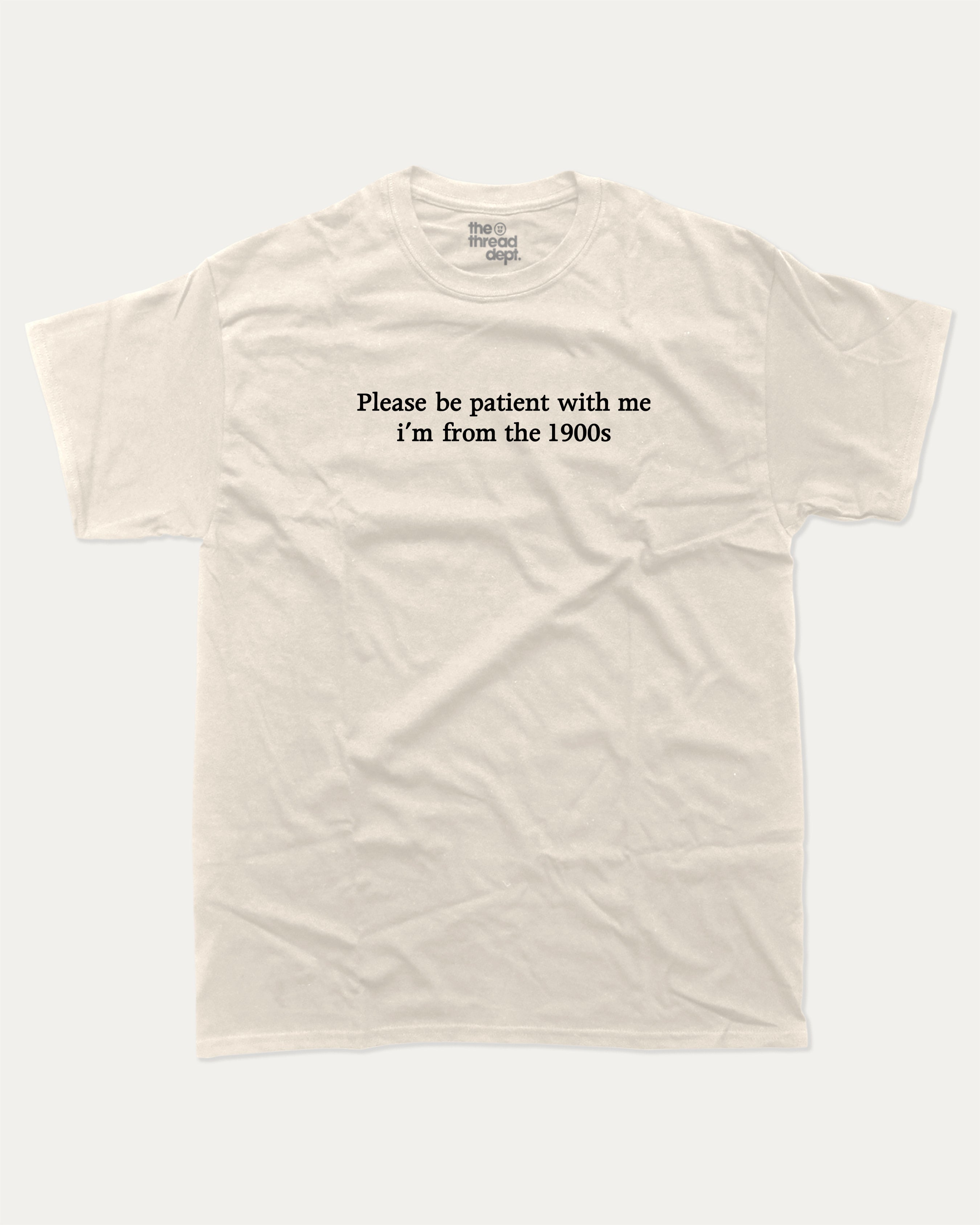 Please Be Patient With Me I'm From The 1900s graphic tee with retro and humorous print, funny and trendy graphic. Perfect for adults and gift-giving. Cream shirt.
