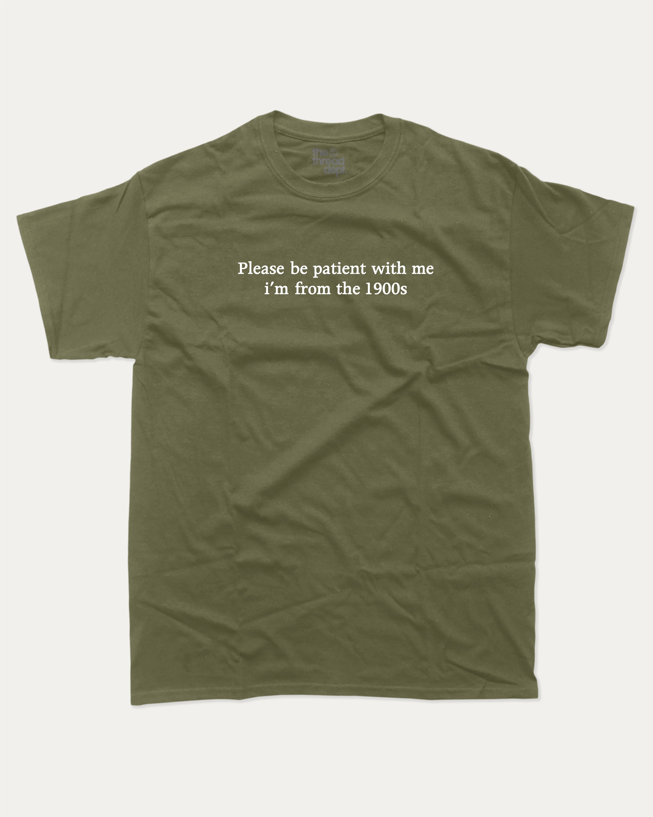 Please Be Patient With Me I'm From The 1900s graphic tee with retro and humorous print, funny and trendy graphic. Perfect for adults and gift-giving. Military Green shirt.