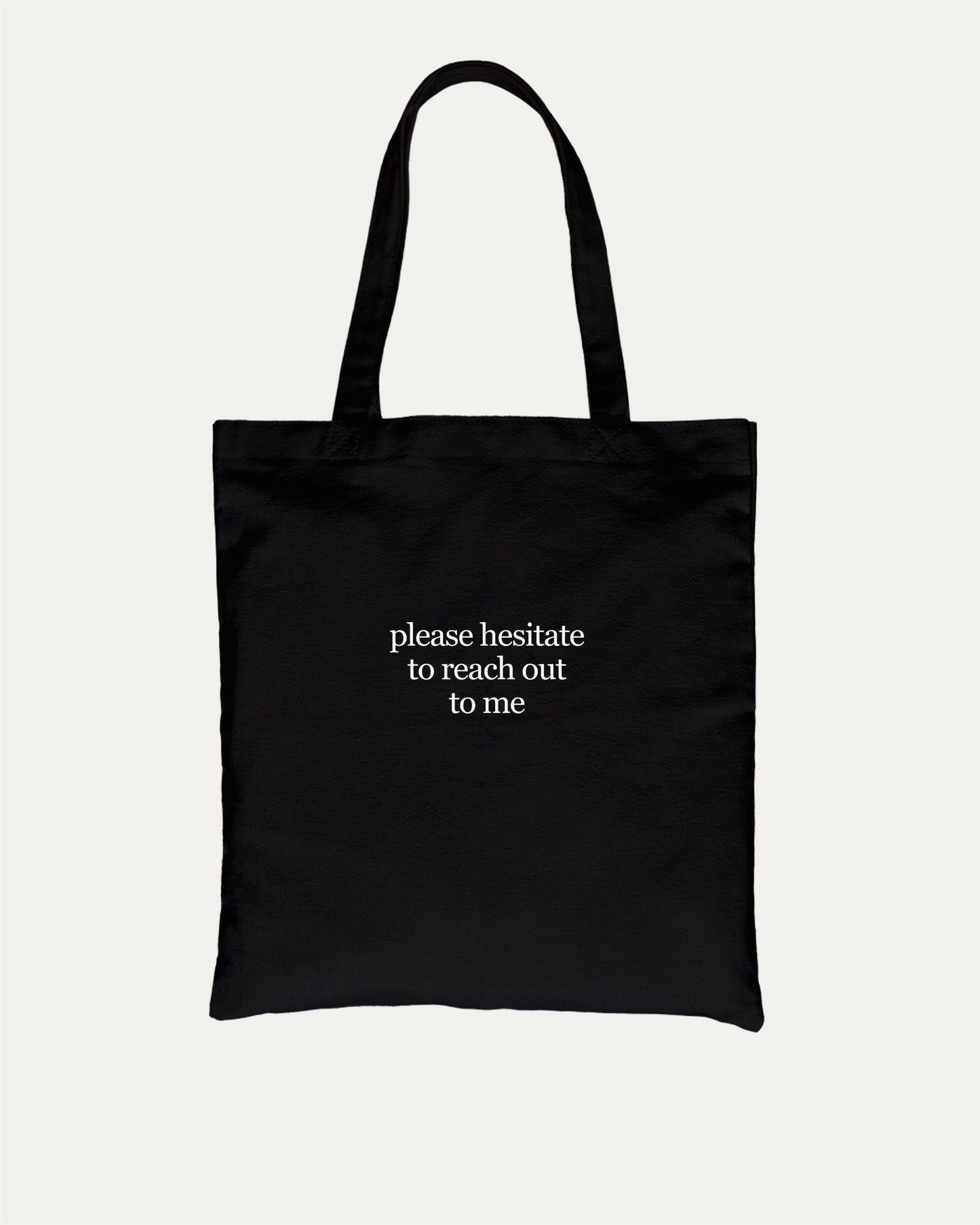 Please Hesitate To Reach Out To Me cotton canvas tote bag with humorous graphic, perfect for everyday carry. A must-have aesthetic accessory, great for shopping, school, or casual days. Special gifts for friends. Black bag