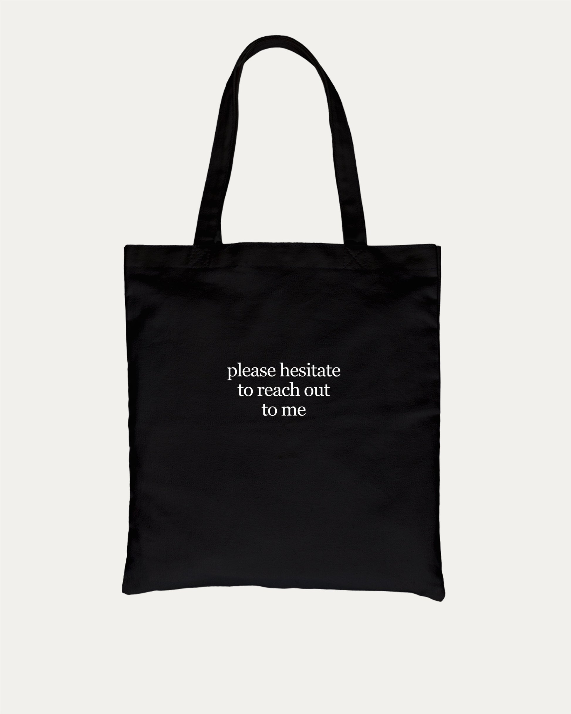 Please Hesitate To Reach Out To Me cotton canvas tote bag with humorous graphic, perfect for everyday carry. A must-have aesthetic accessory, great for shopping, school, or casual days. Special gifts for friends. Black bag