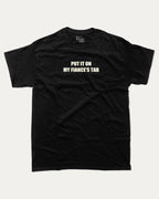 Put It On My Fiance's Tab graphic tee with bold and humorous print, funny and trendy graphic. Perfect for adults and gift-giving. Black shirt.