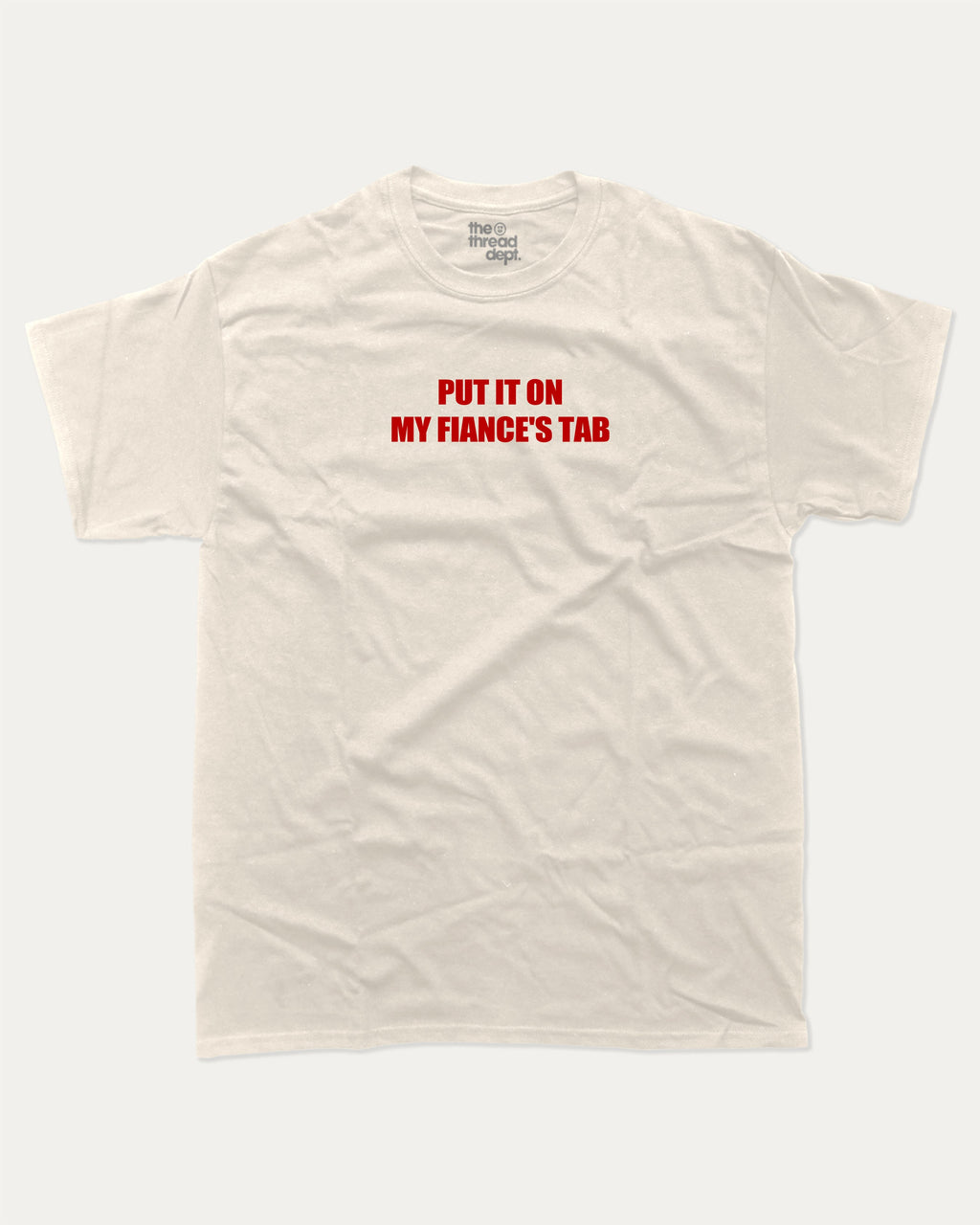 Put It On My Fiance's Tab graphic tee with bold and humorous print, funny and trendy graphic. Perfect for adults and gift-giving. Cream shirt.