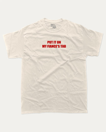 Put It On My Fiance's Tab graphic tee with bold and humorous print, funny and trendy graphic. Perfect for adults and gift-giving. Cream shirt.