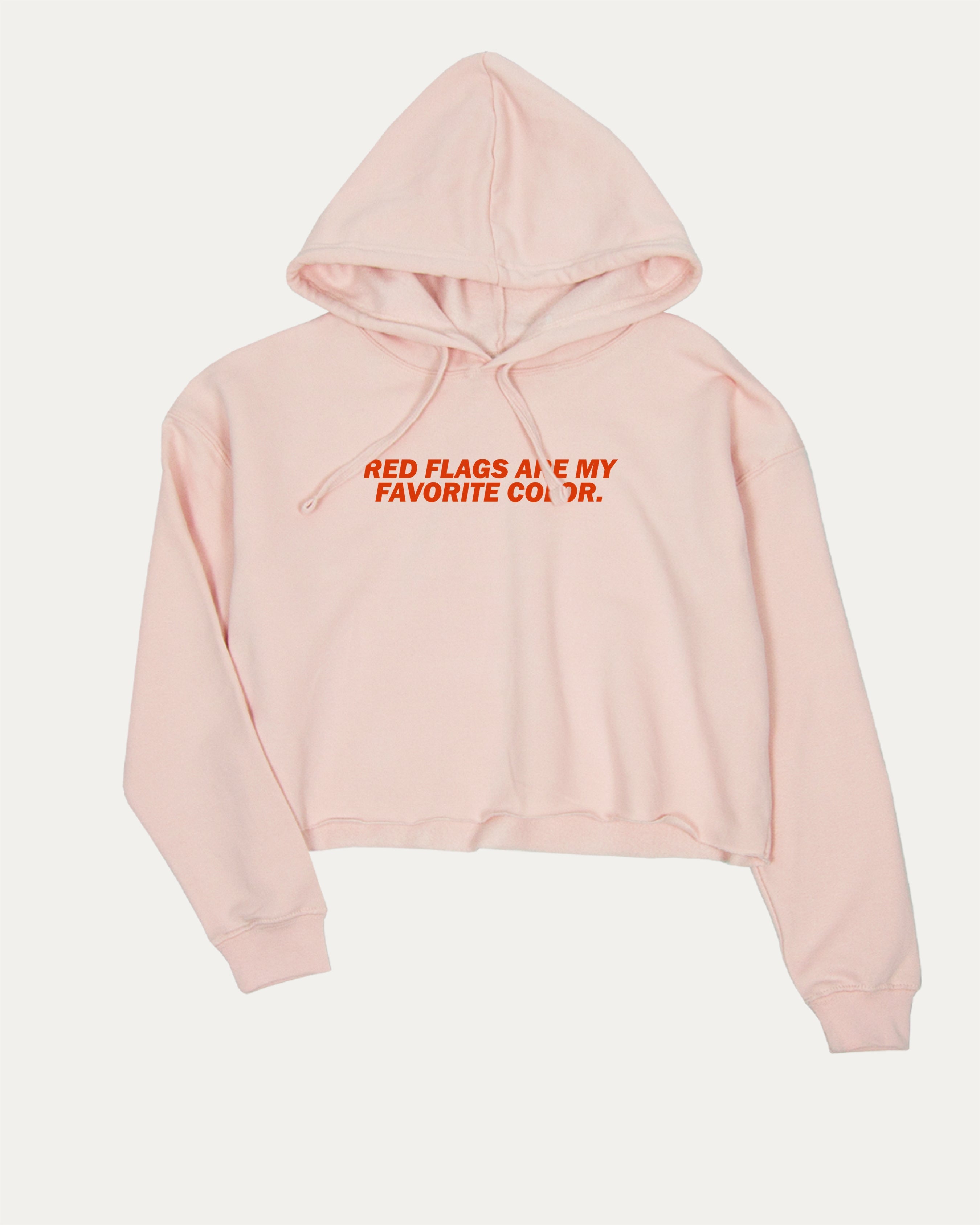 Red Flags Are My Favorite Color graphic crop hoodie with bold slogan print, stylish and playful design for women. Ideal for gifting and casual looks. Pink crop top..