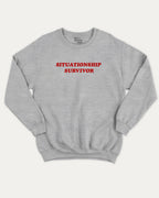 Situationship Survivor graphic sweatshirt with bold and humorous print, warm and cozy graphic for everyday wear. Perfect for adults and gift-giving. Heather Grey pullover.