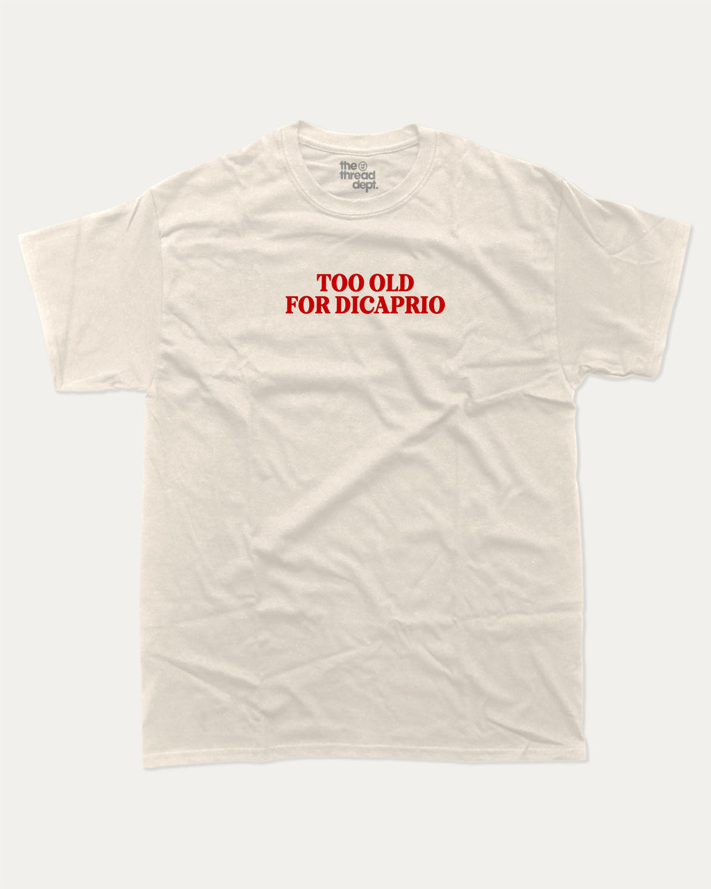 Too Old For Dicaprio graphic tee with bold and humorous print, funny and trendy graphic. Perfect for adults and gift-giving. Cream shirt.