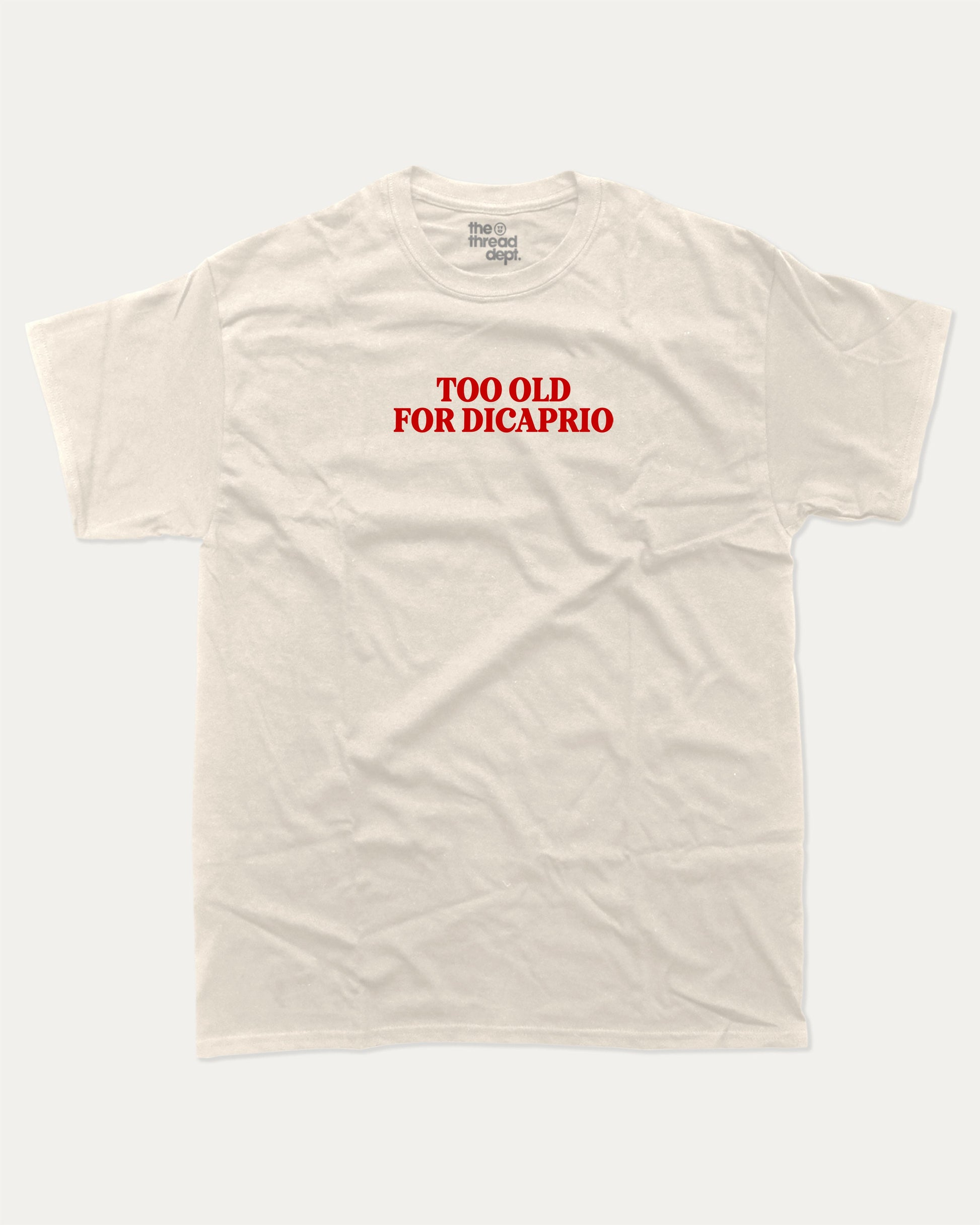 Too Old For Dicaprio graphic tee with bold and humorous print, funny and trendy graphic. Perfect for adults and gift-giving. Cream shirt.