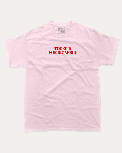 Too Old For Dicaprio graphic tee with bold and humorous print, funny and trendy graphic. Perfect for adults and gift-giving. Pink shirt.