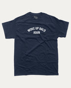 Woke Up Bald Again graphic tee with bold and humorous print, funny and trendy graphic. Perfect for adults and gift-giving. True Navy shirt.