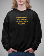 Person wearing a black sweatshirt with yellow text on a gray background