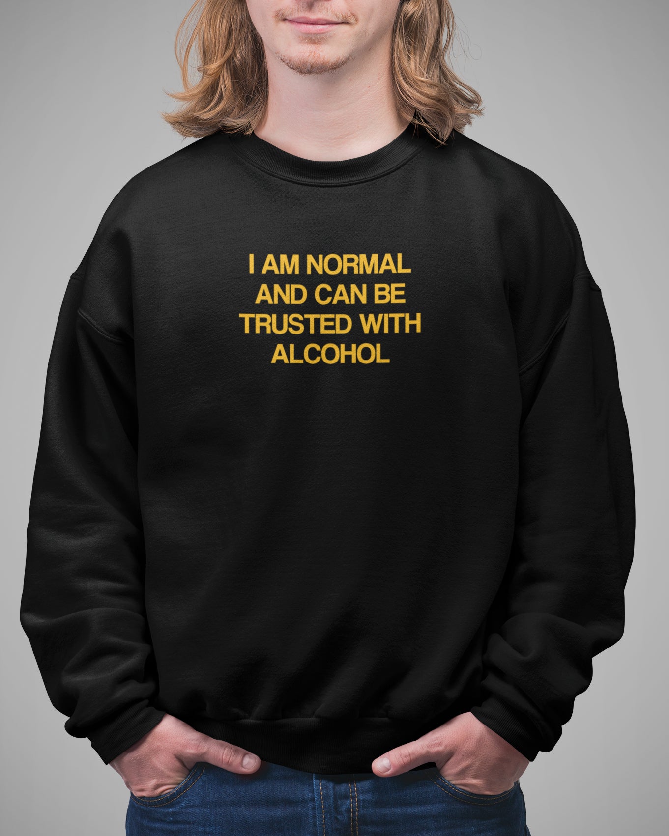 Person wearing a black sweatshirt with yellow text on a gray background