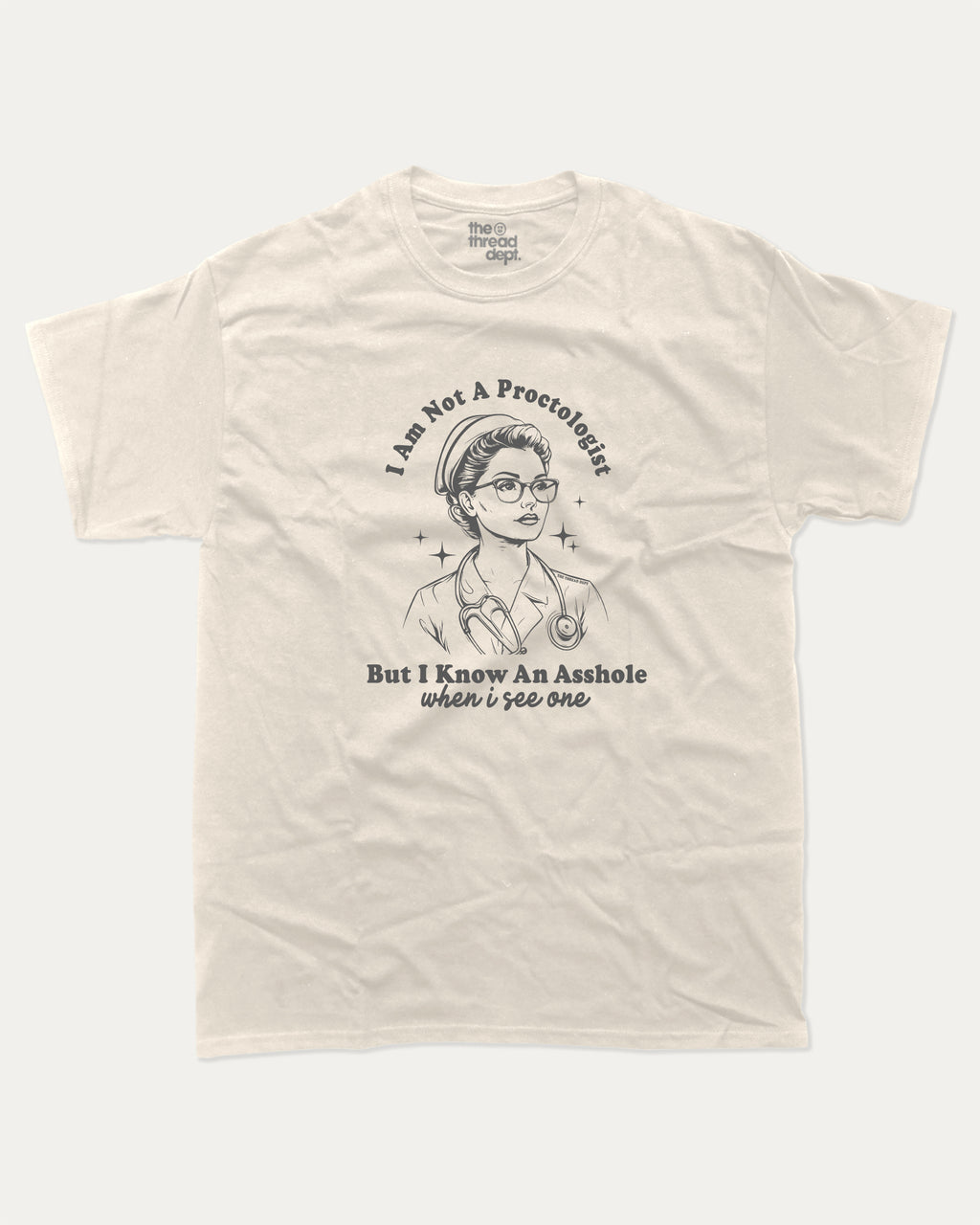 Beige t-shirt with I am not a Proctologist but I know asshole when I see one graphic and text on a white background