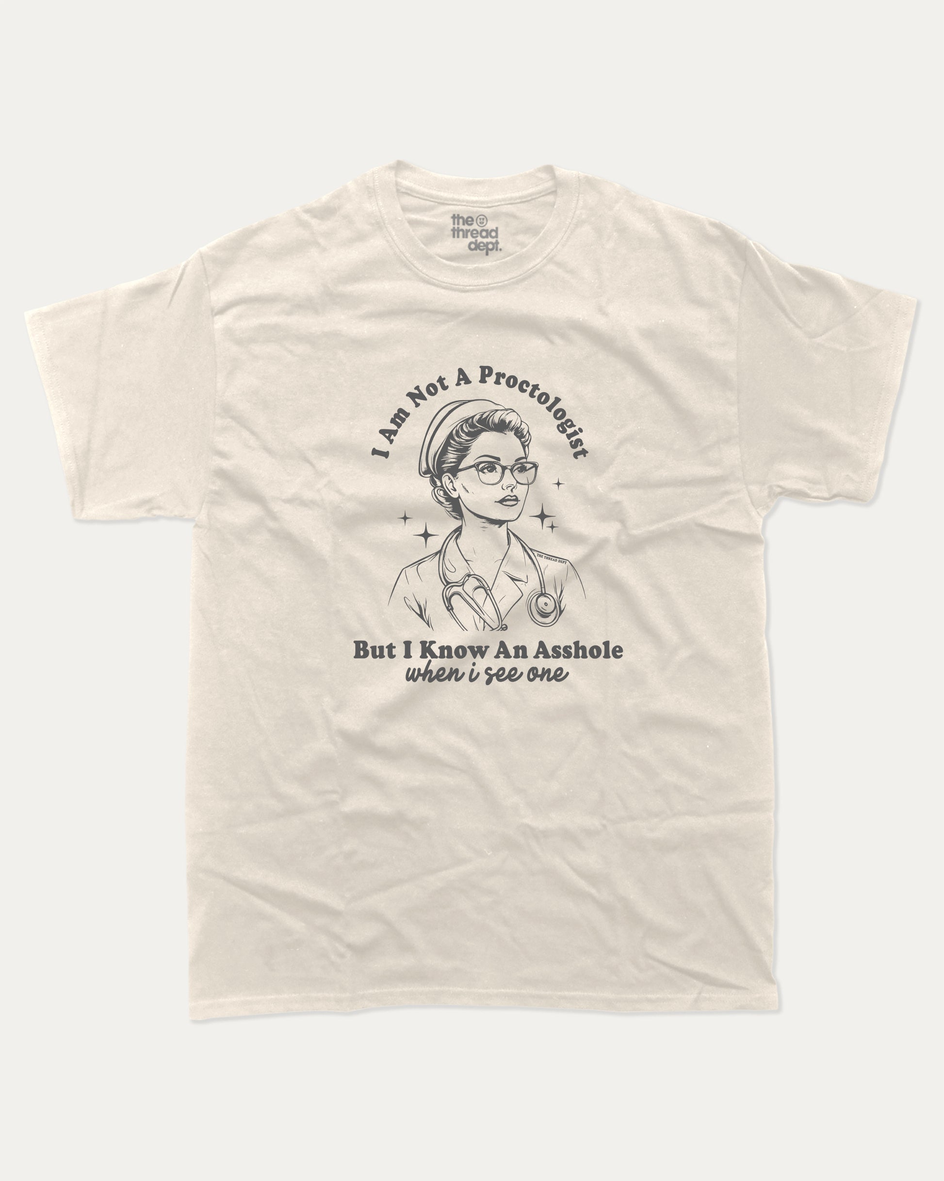 Beige t-shirt with I am not a Proctologist but I know asshole when I see one graphic and text on a white background