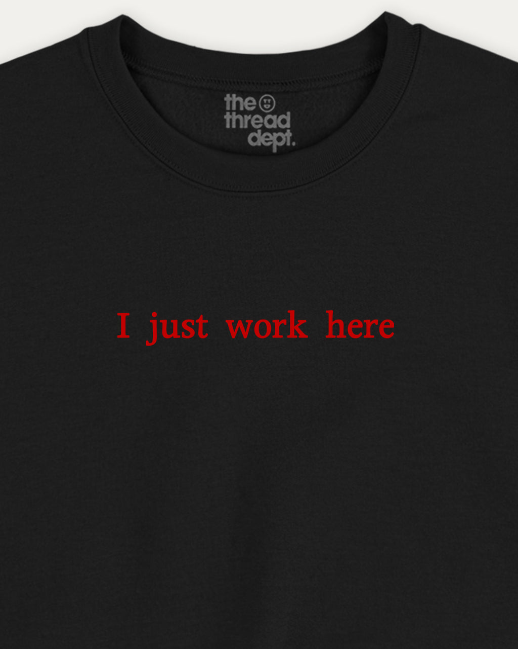 Black t-shirt with red text 'I just work here' and 'the thread dept.' logo on a white background
