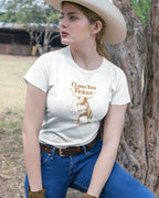 Person wearing a white t-shirt with 'I Love You Texas' graphic outdoors.