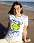 Woman wearing a white t-shirt with vintage lemon-themed design on a beach