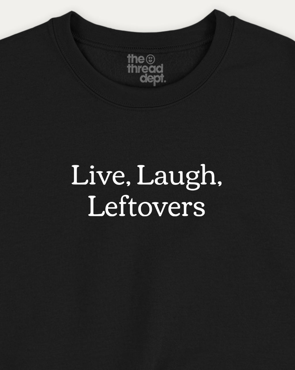 Black t-shirt with 'Live. Laugh. Leftovers' text and 'the thread dept.' branding.