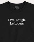 Black t-shirt with 'Live. Laugh. Leftovers' text and 'the thread dept.' branding.