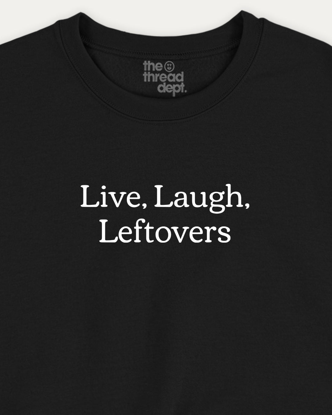 Black t-shirt with 'Live. Laugh. Leftovers' text and 'the thread dept.' branding.