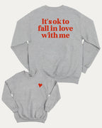 It's ok to fall in love with me graphic sweatshirt with bold and humorous print, Valentine Day Graphic T shirt, Perfect Gift for Valentine's Day, warm and cozy graphic for everyday wear. Perfect for adults and gift-giving. Heather Grey pullover.