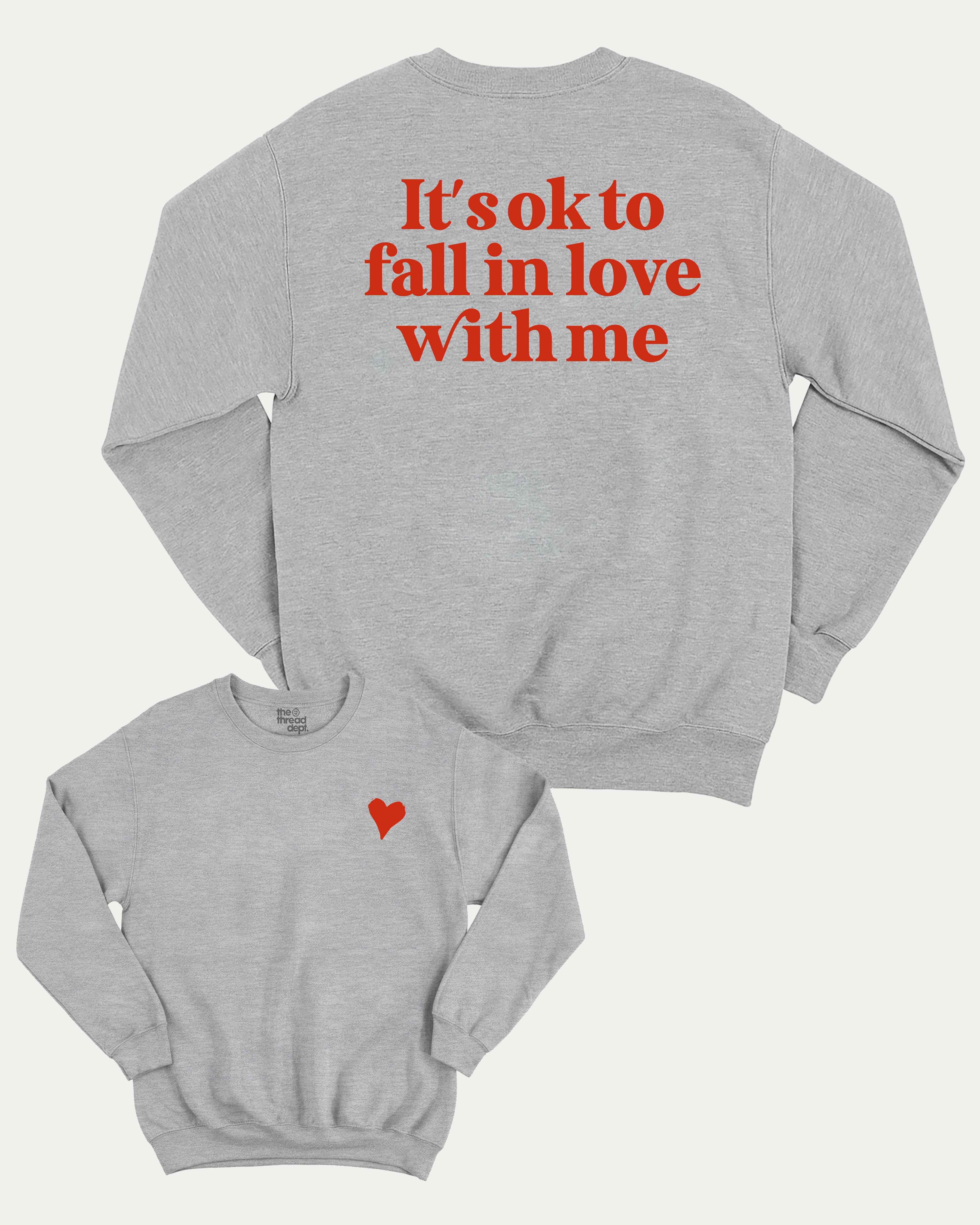 It's ok to fall in love with me graphic sweatshirt with bold and humorous print, Valentine Day Graphic T shirt, Perfect Gift for Valentine's Day, warm and cozy graphic for everyday wear. Perfect for adults and gift-giving. Heather Grey pullover.