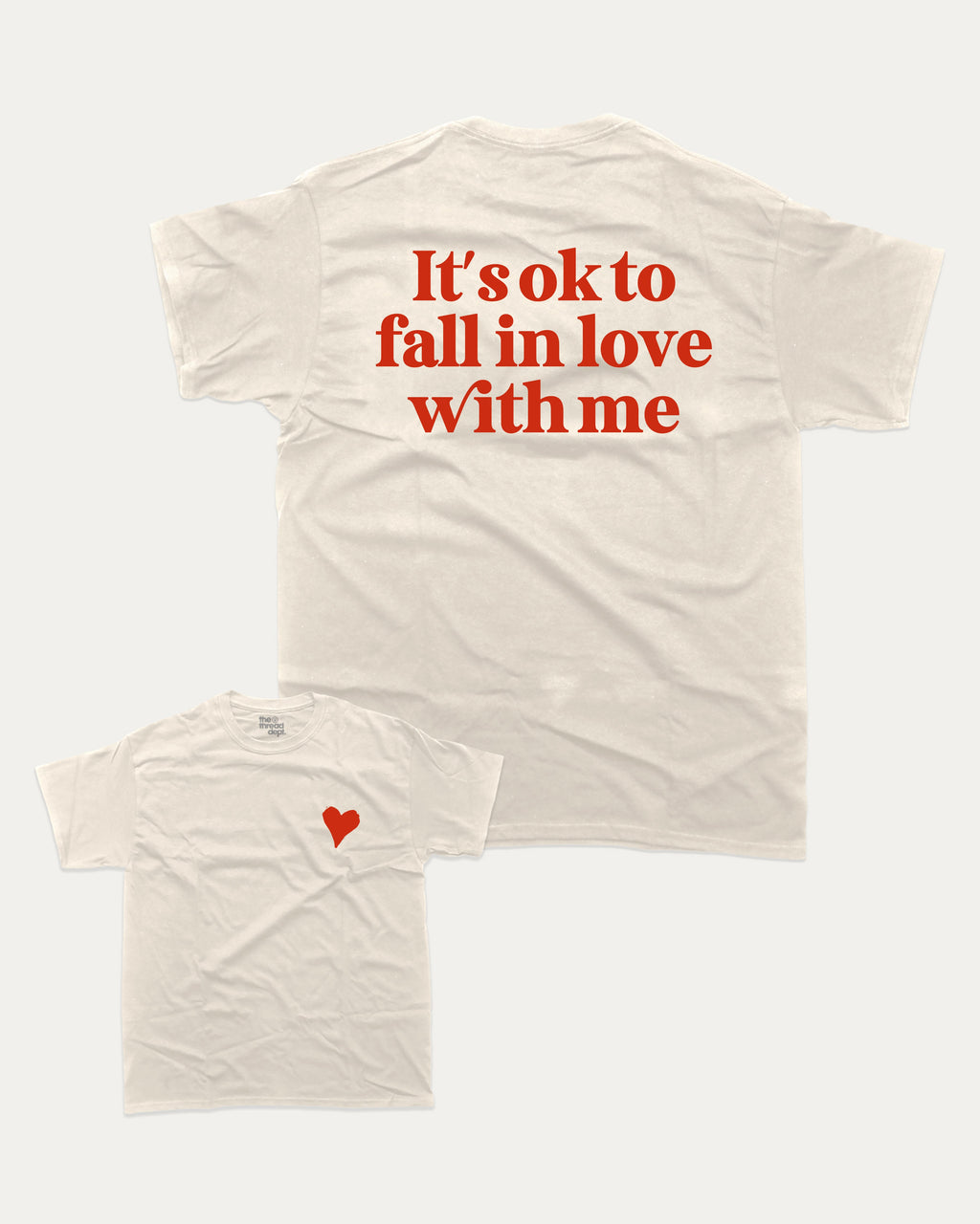 It's ok to fall in love with me graphic tee with bold and humorous print, Valentine Day Graphic T shirt, Perfect Gift for Valentine's Day, funny and trendy graphic. Perfect for adults and gift-giving. Cream shirt.