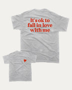 It's ok to fall in love with me graphic tee with bold and humorous print, Valentine Day Graphic T shirt, Perfect Gift for Valentine's Day, funny and trendy graphic. Perfect for adults and gift-giving. Heather Grey shirt.