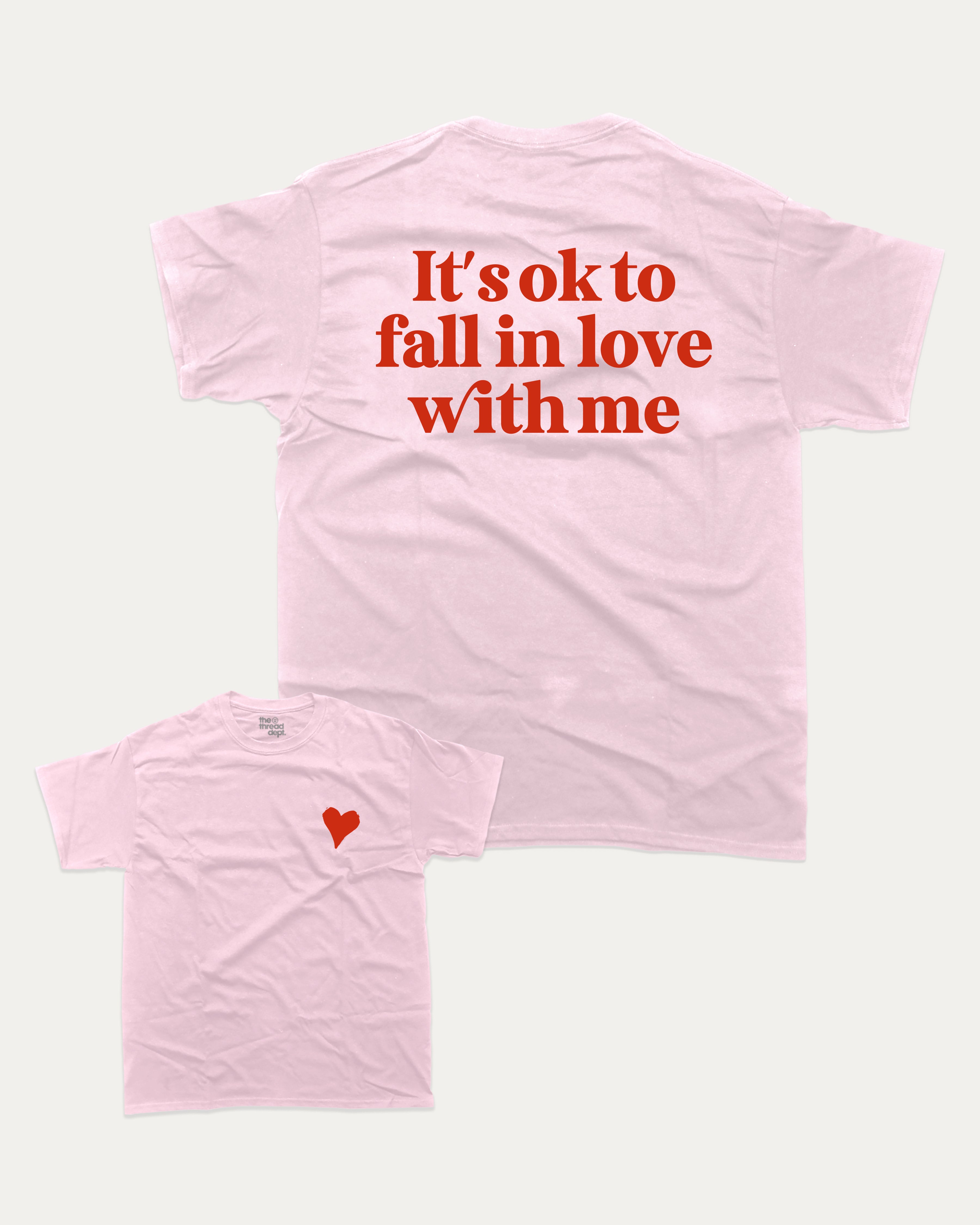It's ok to fall in love with me graphic tee with bold and humorous print, Valentine Day Graphic T shirt, Perfect Gift for Valentine's Day, funny and trendy graphic. Perfect for adults and gift-giving. Pink shirt.