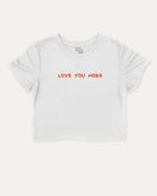 Love You More graphic crop tee with funny and trendy slogan print, perfect for women’s casual looks or layering. White crop t-shirt.