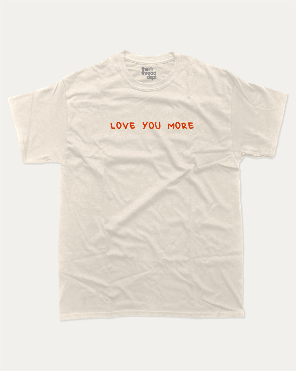 Love You More graphic tee with funny valentine print, trendy love graphic. Perfect for Valentine's Day gift-giving. Cream shirt.