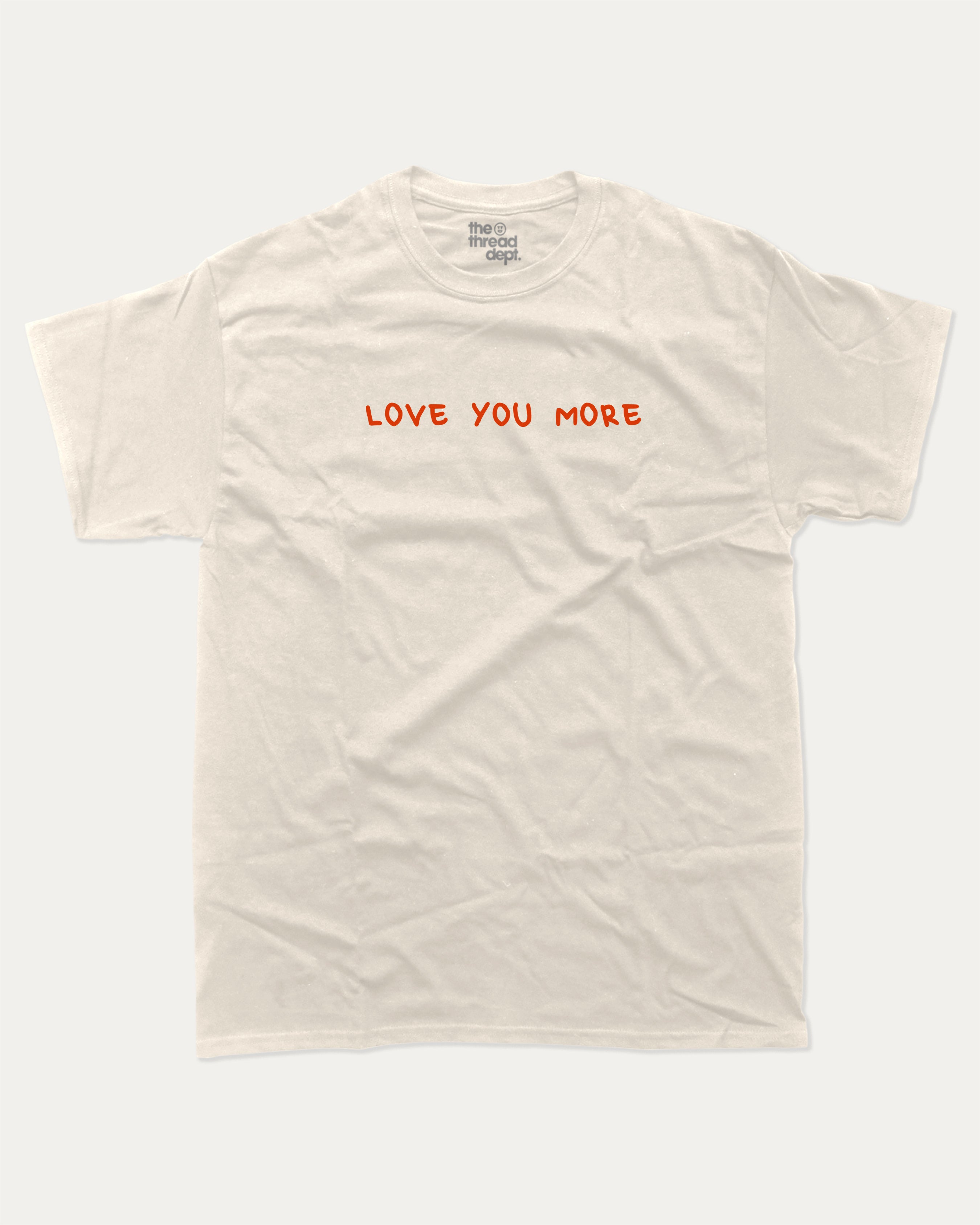 Love You More graphic tee with funny valentine print, trendy love graphic. Perfect for Valentine's Day gift-giving. Cream shirt.