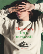 Person wearing a sweatshirt with 'Mommy's little meatball' text and graphic.
