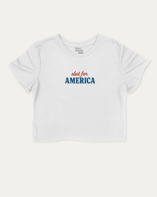 Slut For America graphic crop tee with funny and trendy slogan print, perfect for women’s casual looks or layering. White crop t-shirt.