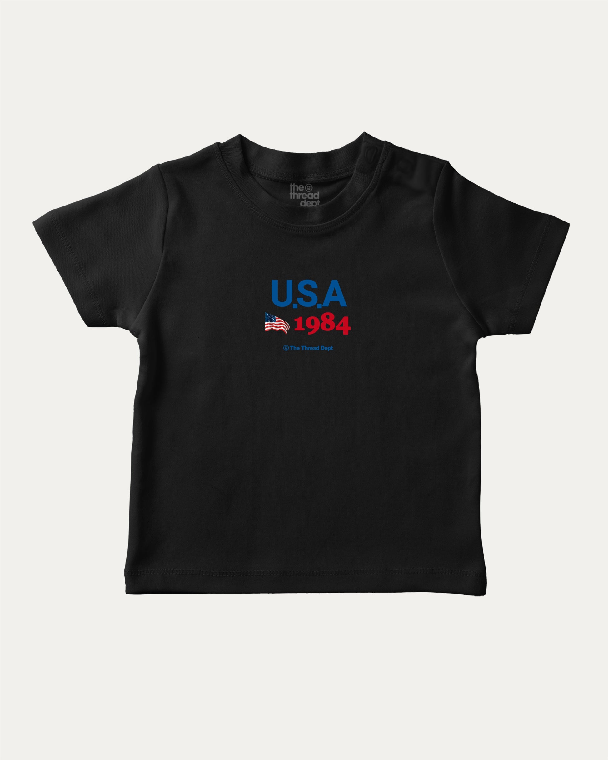 USA 1984 playful kids' graphic tee, perfect for boys and girls. A must-have fun shirt for school, playtime, or gifting. Black baby t-shirt