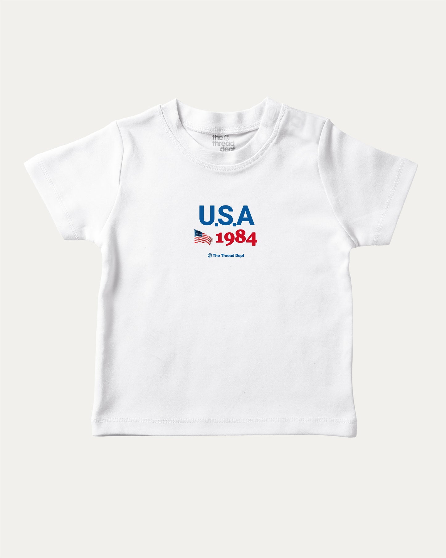 USA 1984 playful kids' graphic tee, perfect for boys and girls. A must-have fun shirt for school, playtime, or gifting. White baby t-shirt