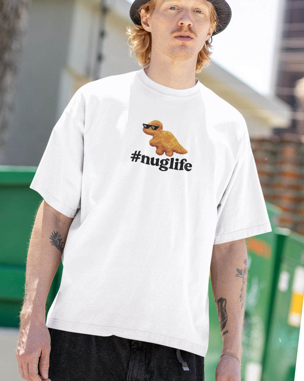 Person wearing a white t-shirt with a #Nuglife graphic and text, standing outdoors.