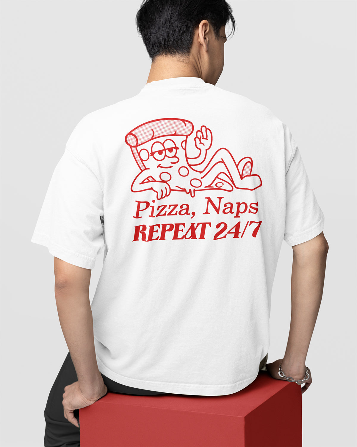 Person wearing a white t-shirt with red graphics and text on the back.