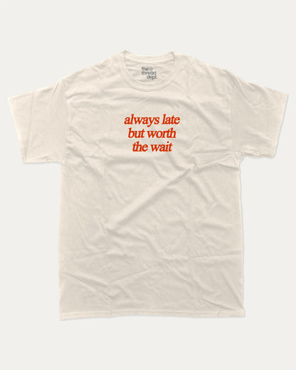 always late but worth the wait graphic tee with bold and humorous print, funny and trendy graphic. Perfect for adults and gift-giving. Cream shirt.