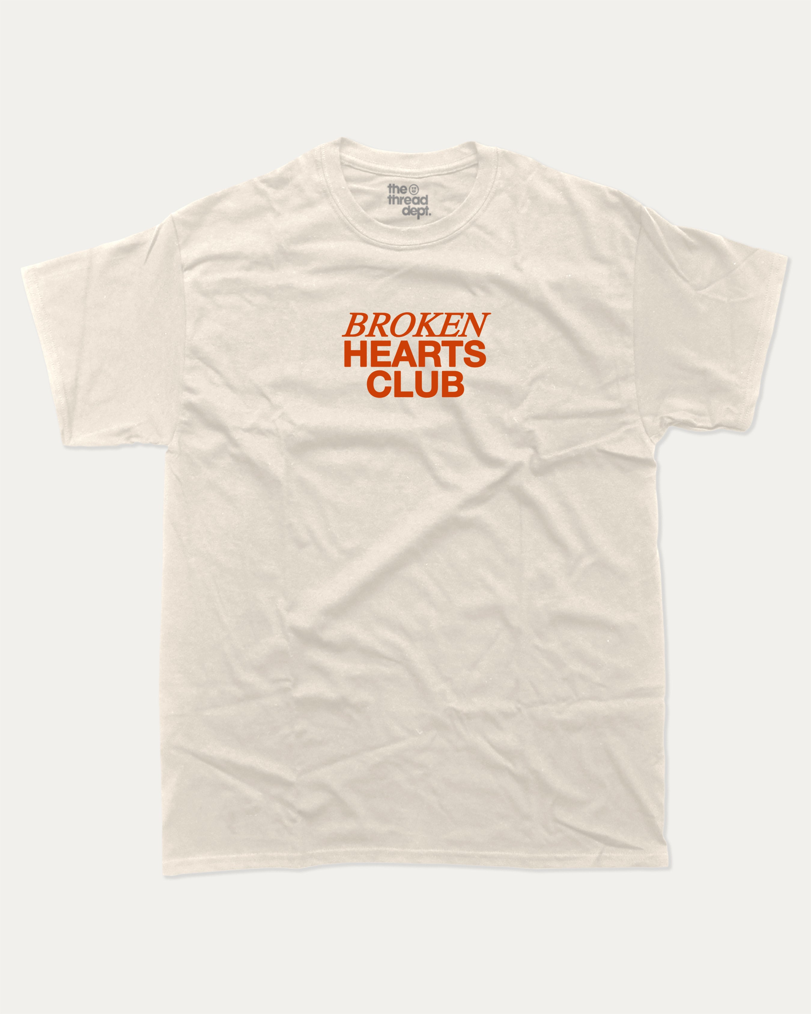 Broken Hearts Club graphic tee with bold and humorous print, funny and trendy graphic. Vintage Inspired Graphic t shirt, Retro Inspired Graphic T shirt,  Perfect for adults and gift-giving. Cream shirt.