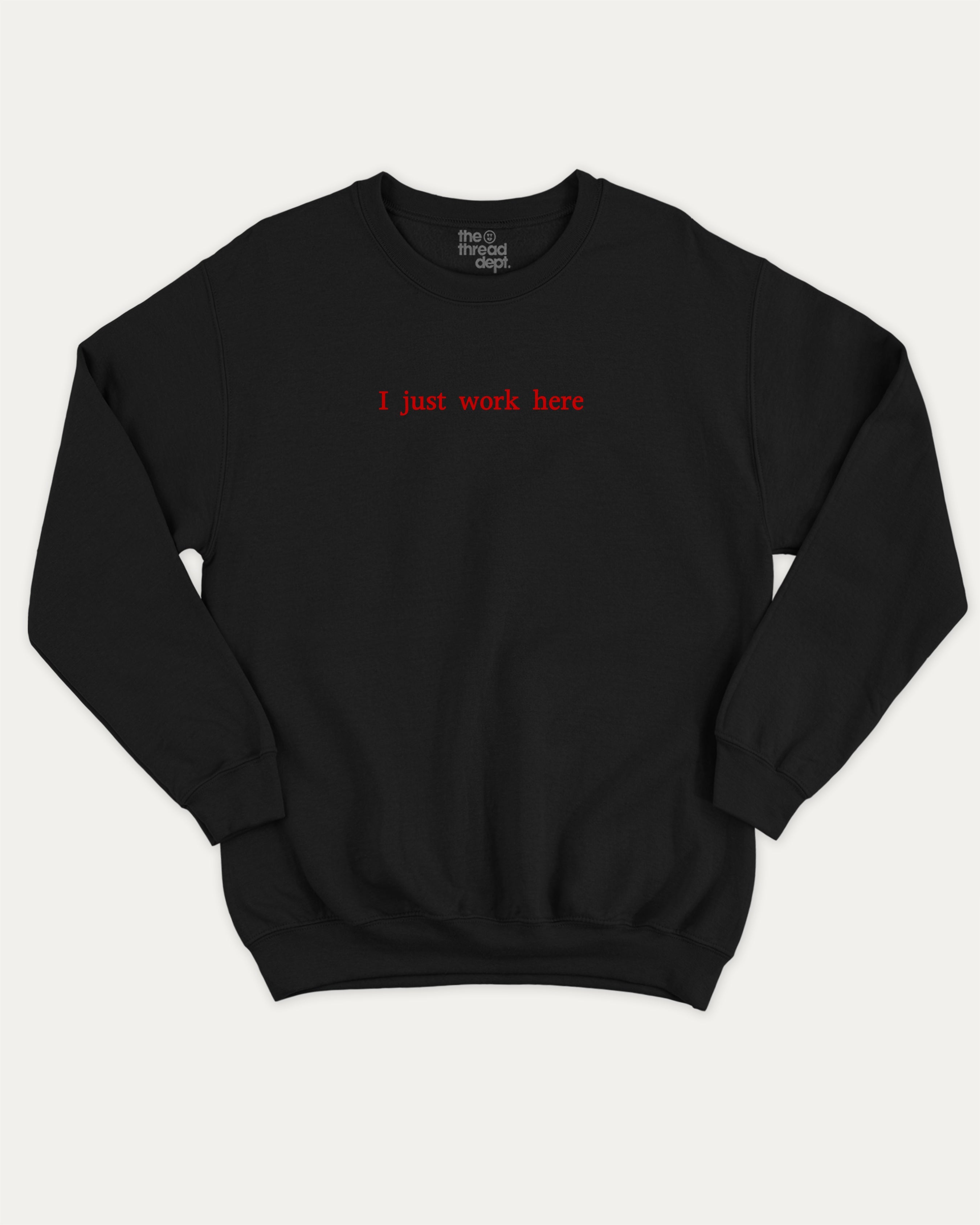 I Just Work Here graphic sweatshirt with bold and retro print, warm and cozy graphic for everyday wear. Perfect for adults and gift-giving. Black pullover.