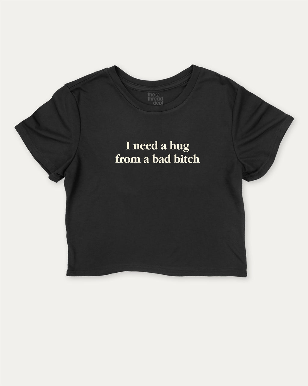 I Need A Hug From A Bad Bitch graphic crop tee with funny and trendy slogan print, perfect for women’s casual looks or layering. Black crop t-shirt.