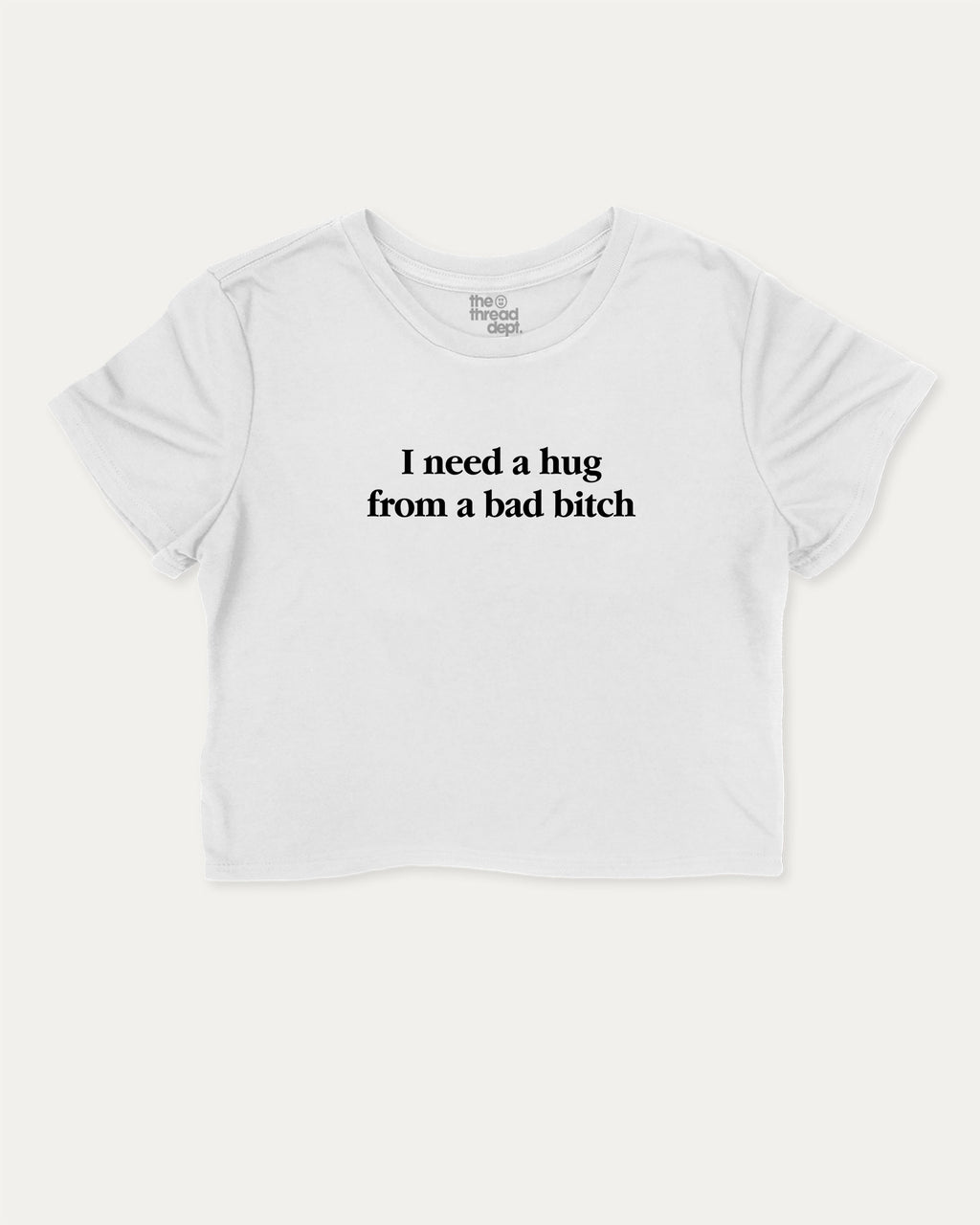 I Need A Hug From A Bad Bitch graphic crop tee with funny and trendy slogan print, perfect for women’s casual looks or layering. White crop t-shirt.