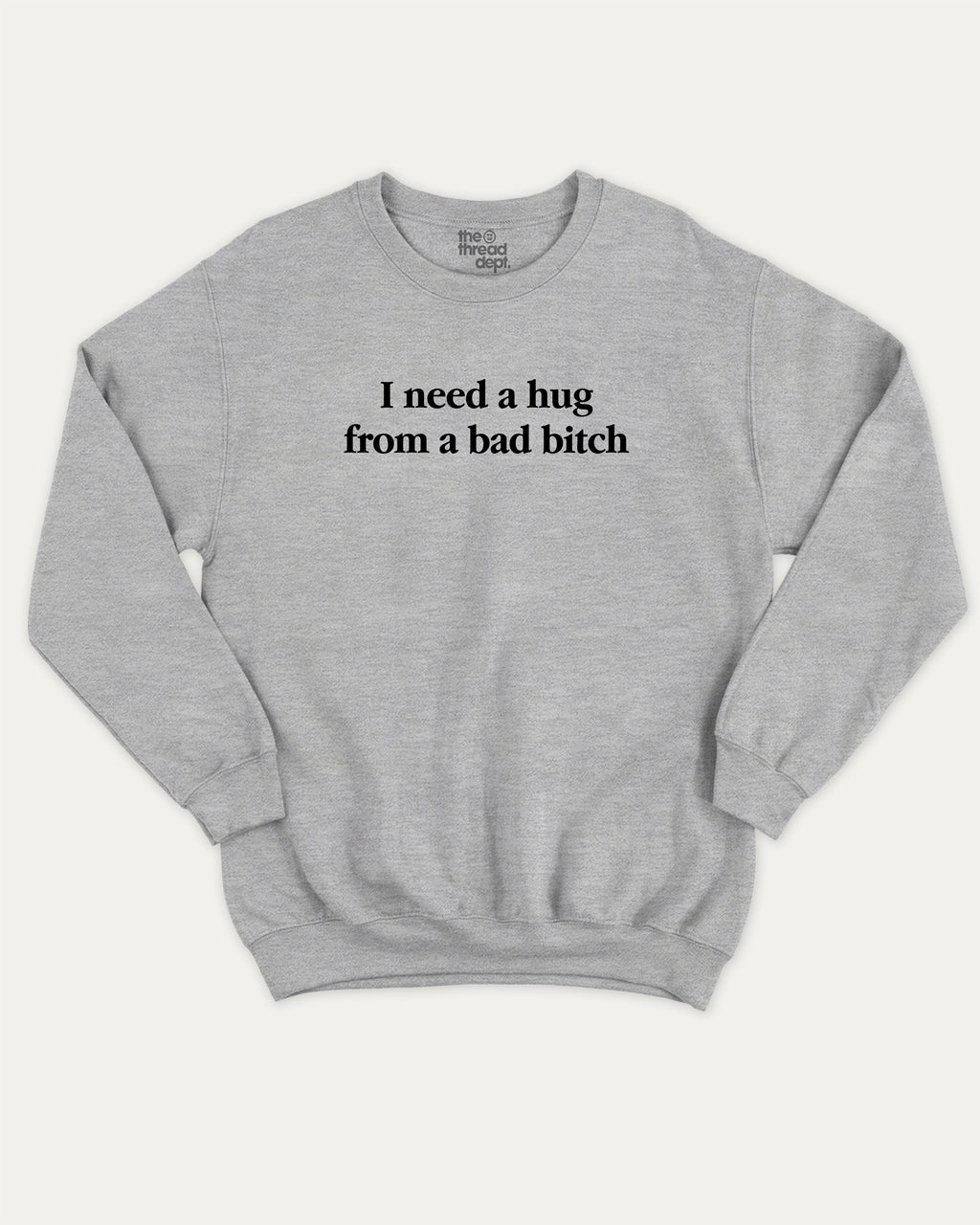 I Need A Hug From A Bad Bitch graphic sweatshirt with bold and funny print, warm and cozy graphic for everyday wear. Perfect for adults and gift-giving. Heather Grey pullover.