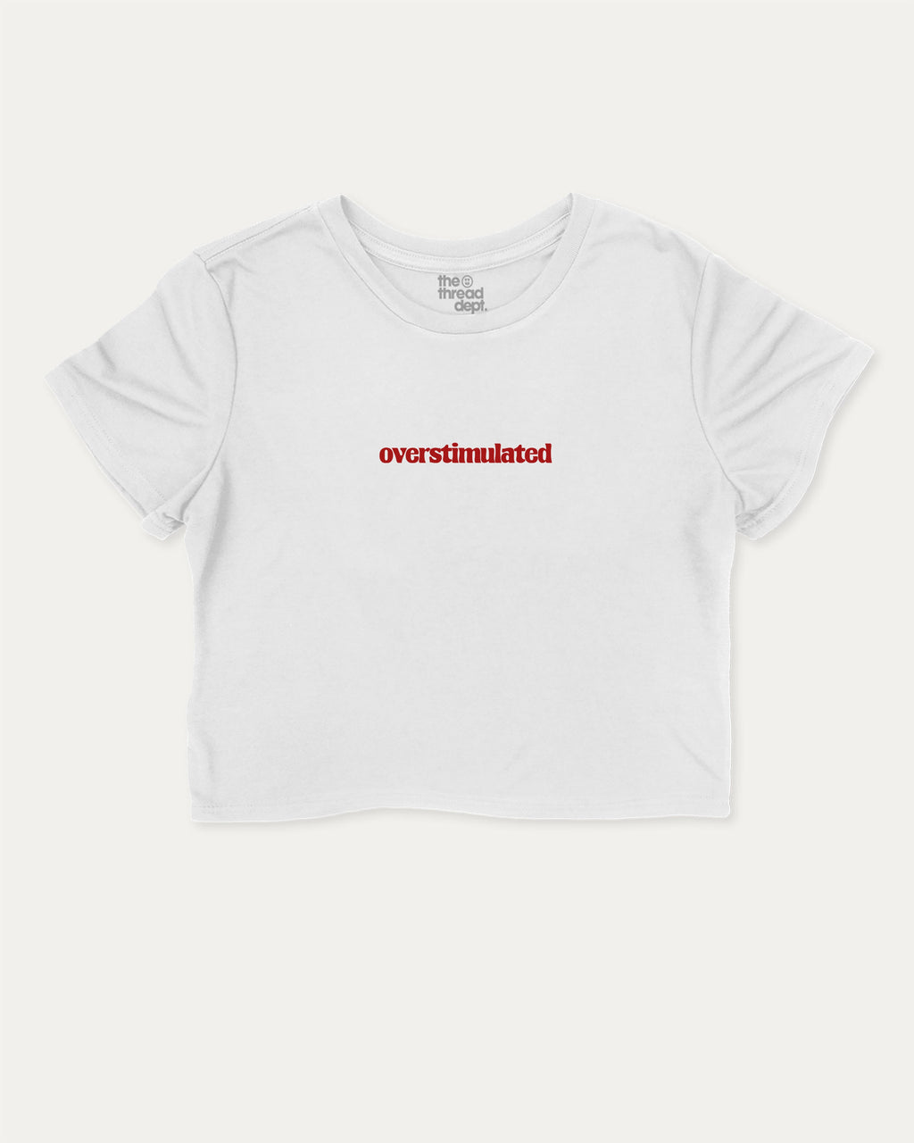 Overstimulated graphic crop tee with funny and trendy slogan print, perfect for women’s casual looks or layering. White crop t-shirt.