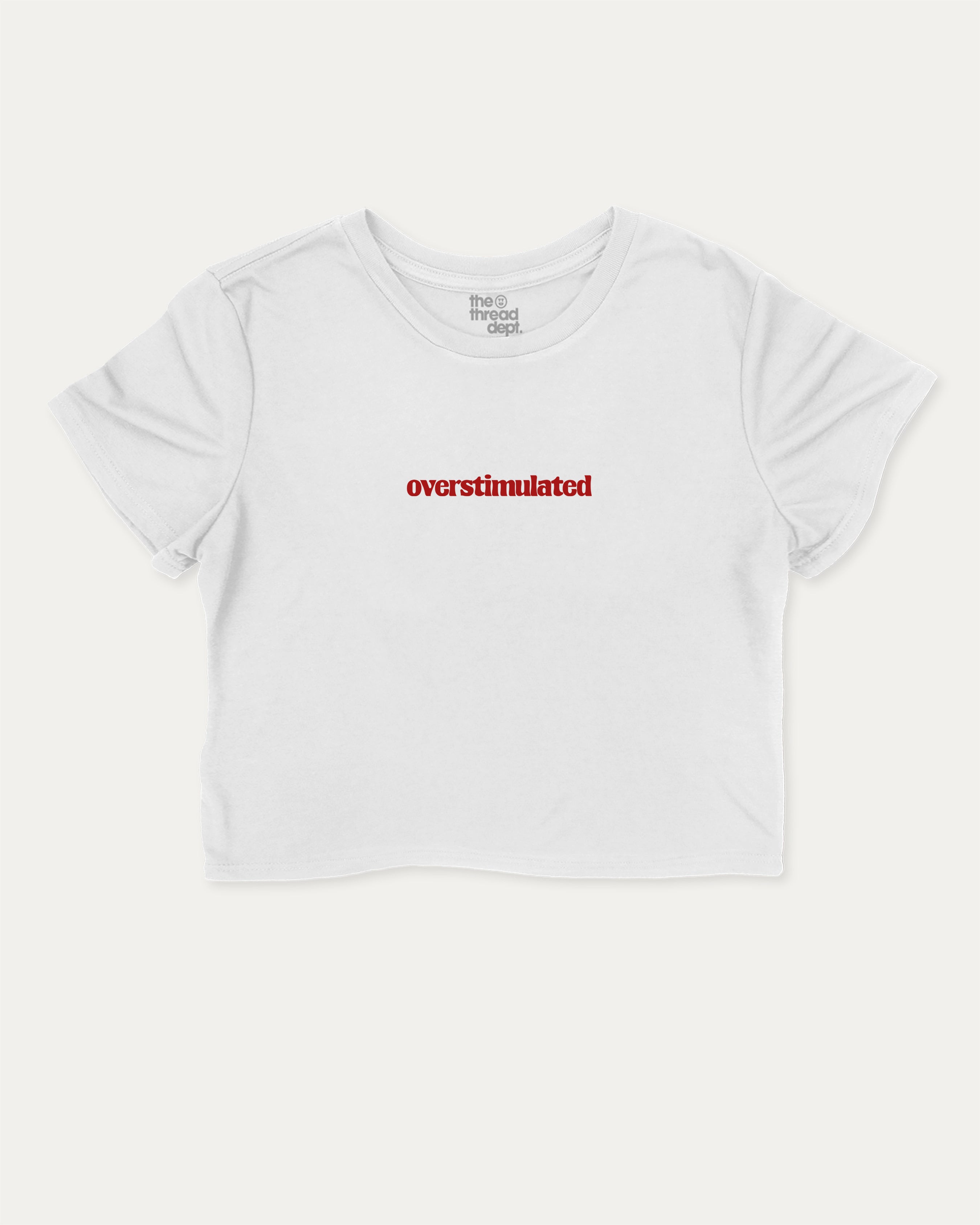 Overstimulated graphic crop tee with funny and trendy slogan print, perfect for women’s casual looks or layering. White crop t-shirt.