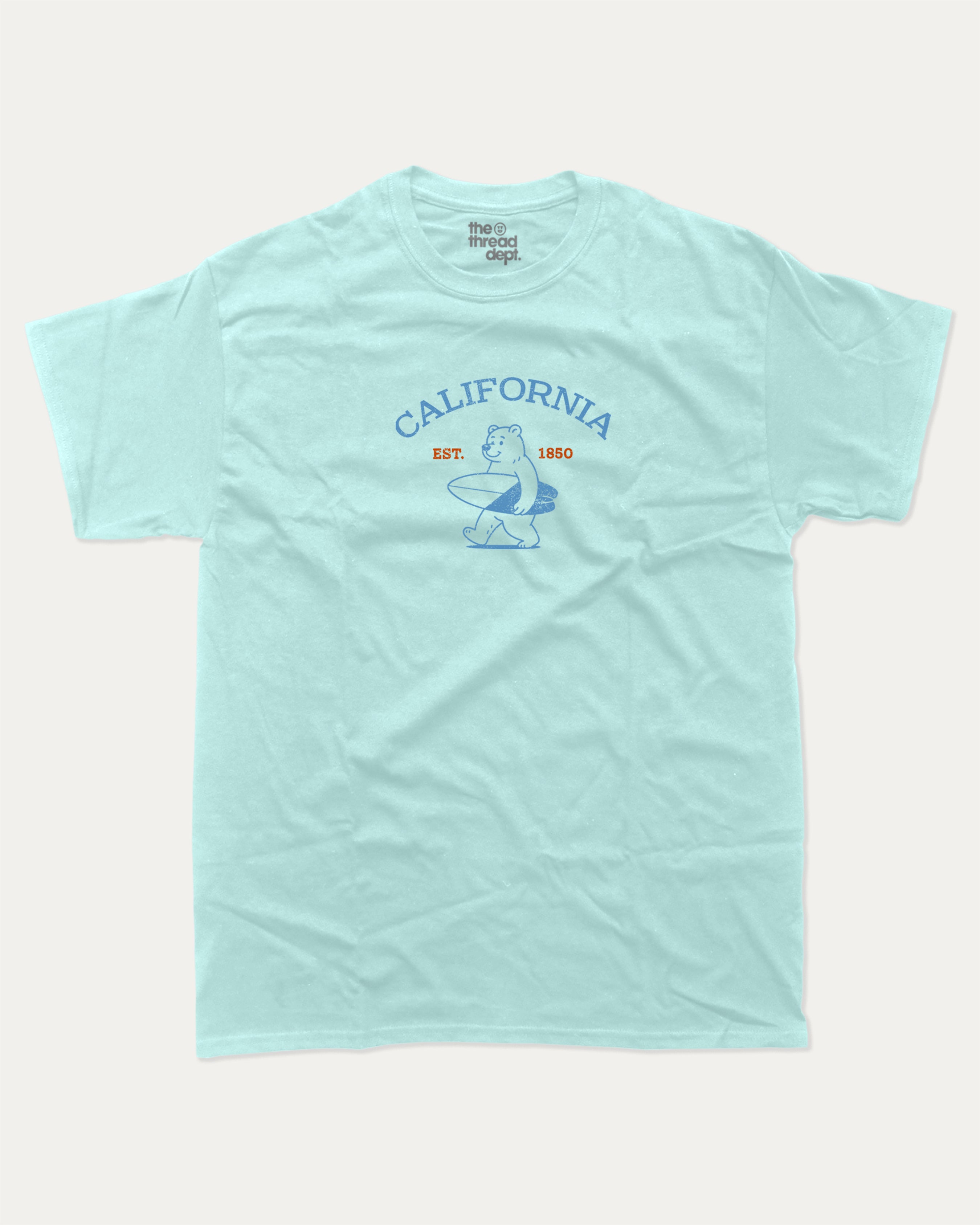 Surf in California graphic tee with bold and humorous print, Retro Inspired Graphic T shirt, Vintage Inspired Graphic T shirt, Perfect Gift for Surfers, State Graphic T shirt, California Graphic T shirt, funny and trendy graphic. Perfect for adults and gift-giving. Celadon shirt.