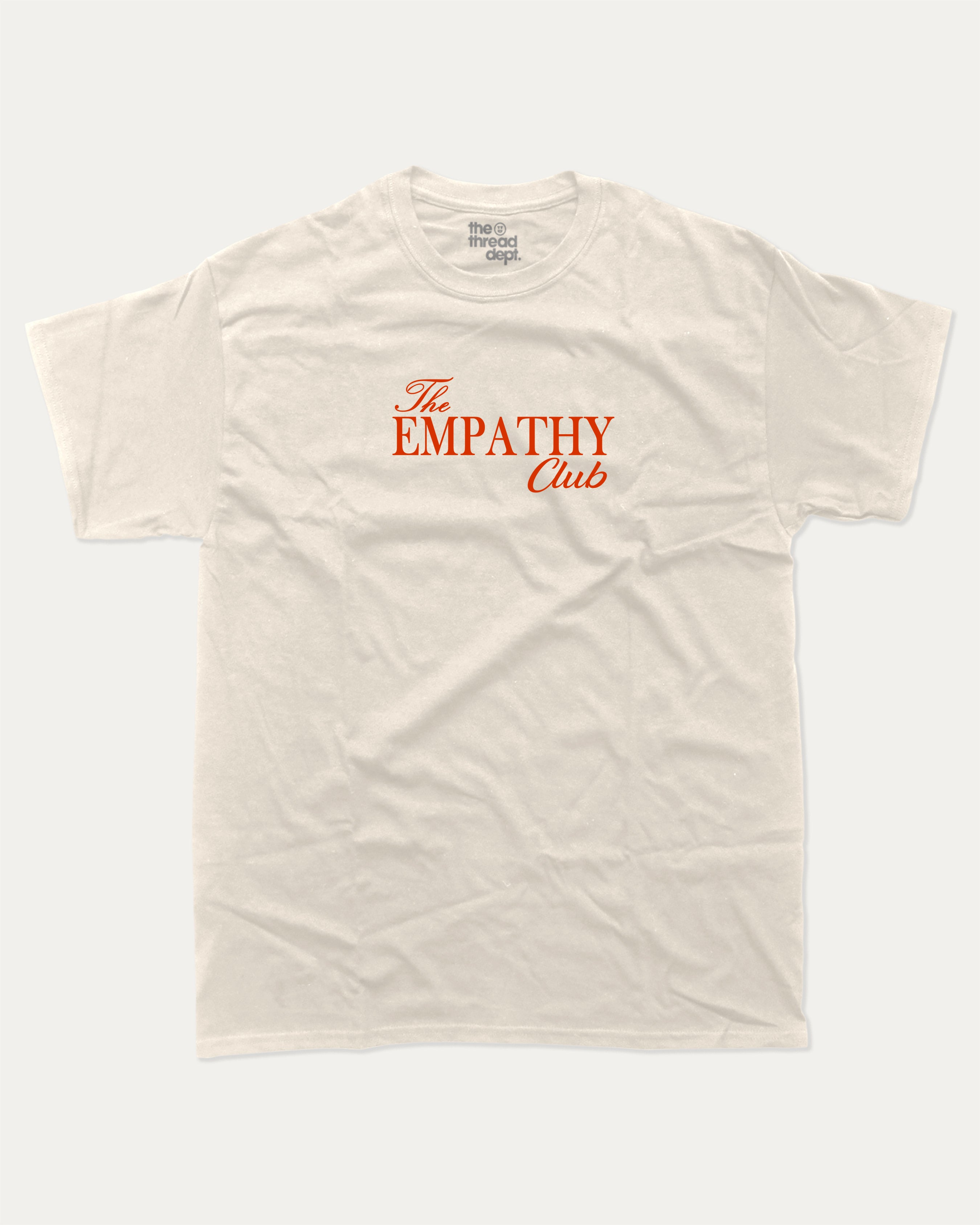 The Empathy Club graphic tee with bold and humorous print, funny and trendy graphic. Perfect for adults and gift-giving. Cream shirt.
